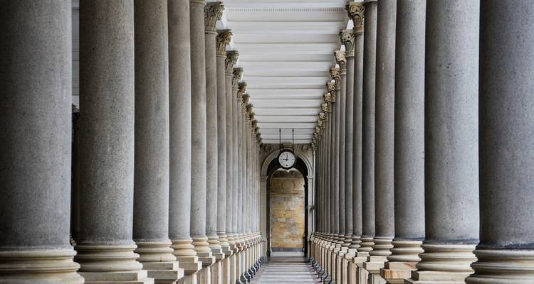 Column walkway with arches and a clock in Karlovy Vary.