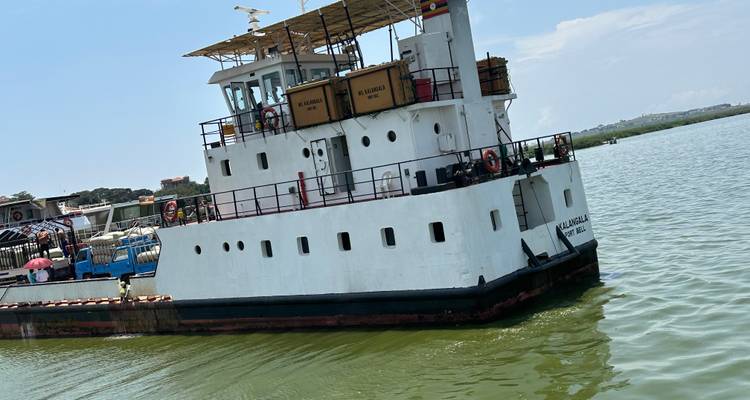 A ferry boat on the water with the name 'MV Kalangala'.