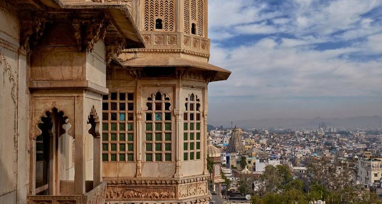 Part of a historic building overlooking a city.