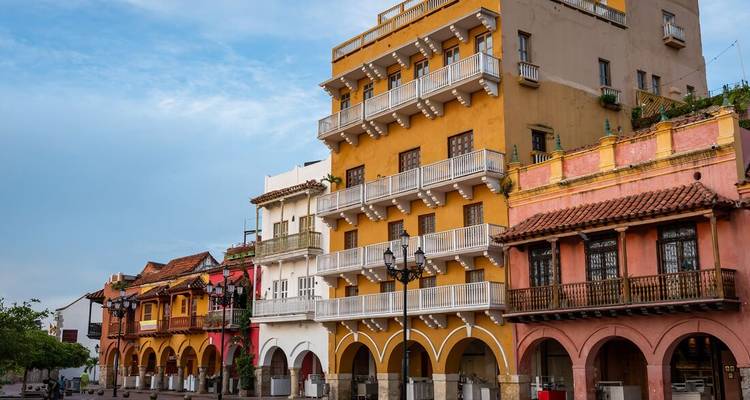 Row of colorful colonial buildings with arcades in Cartagena's historic center