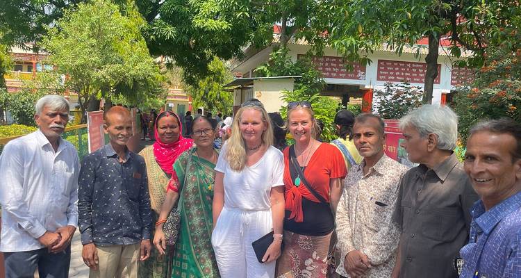 Group of people standing in a garden area posing for a photo.