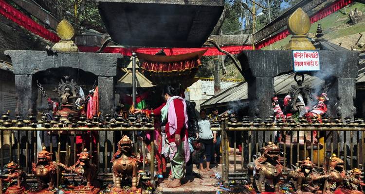 Des personnes visitant un temple traditionnel avec des sculptures complexes.