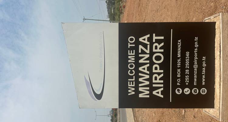 Signboard of Mwanza Airport with airline information.