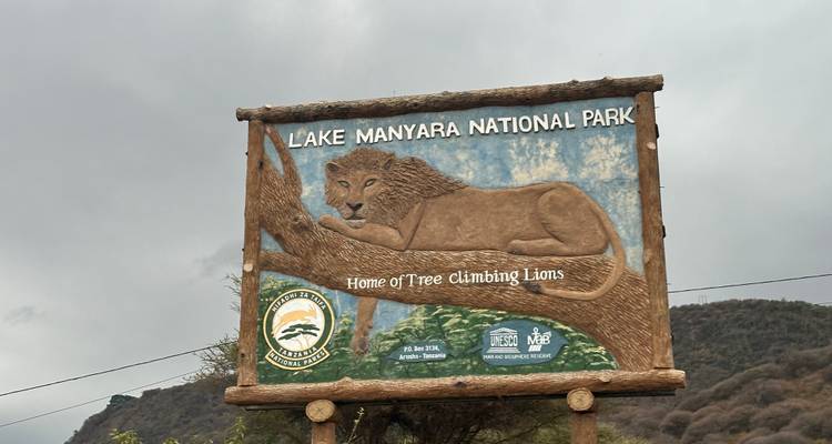 Sign for Lake Manyara National Park with a lion illustration.
