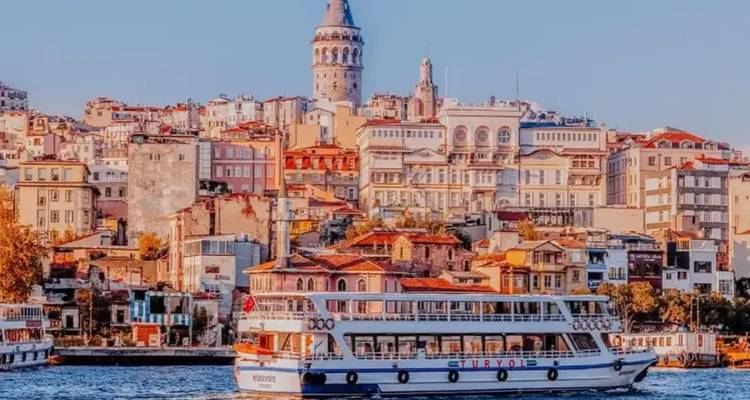 Ferry crossing a busy waterway with a city skyline behind.