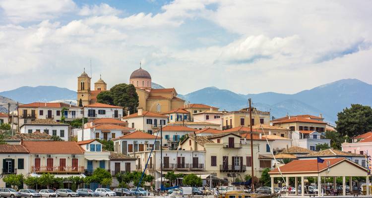 Picturesque town by the sea with colorful buildings and mountains in the background.
