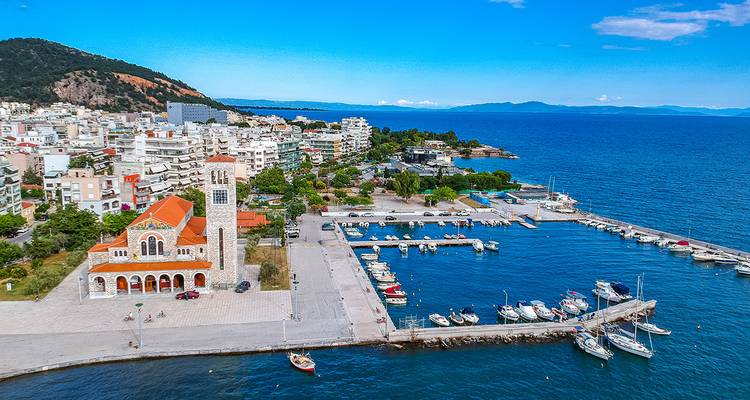 Coastal city view with church and marina, Volos, Greece.