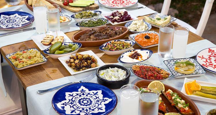 Traditional Greek meal setup with various dishes on a table.