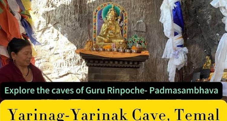 Cave shrine with a statue and decorative items.
