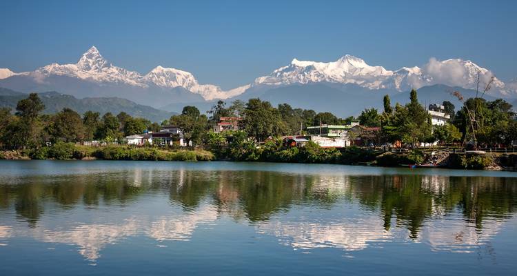 Mountains reflected in a lake with a clear sky.