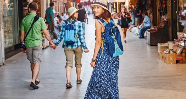 People walking through a busy market street.