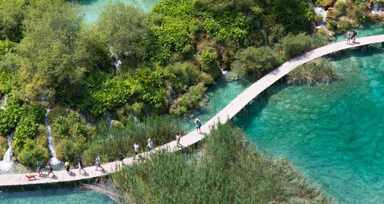 Wooden pathways over clear turquoise waters.
