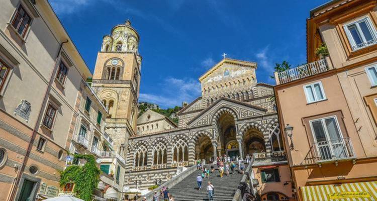 Tourists on the grand staircase of a cathedral.
