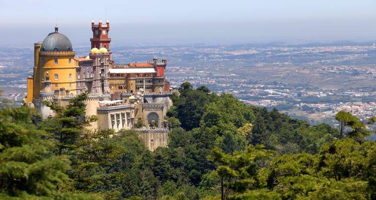 Pena Palace nestled on a forested hill with expansive views.