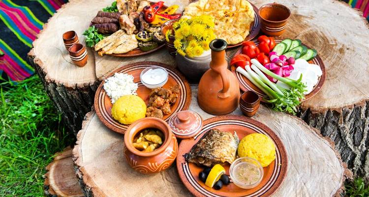 Traditional Romanian meal spread on wooden table.