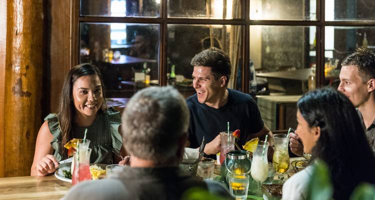 Grupo de personas cenando juntas en un restaurante acogedor.