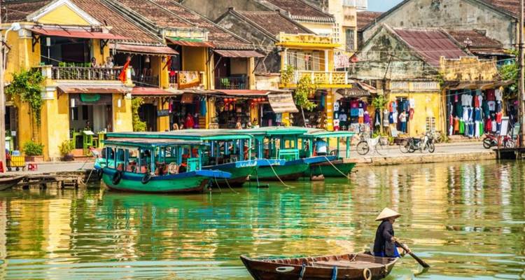 Charming riverside town with colorful buildings and boats.