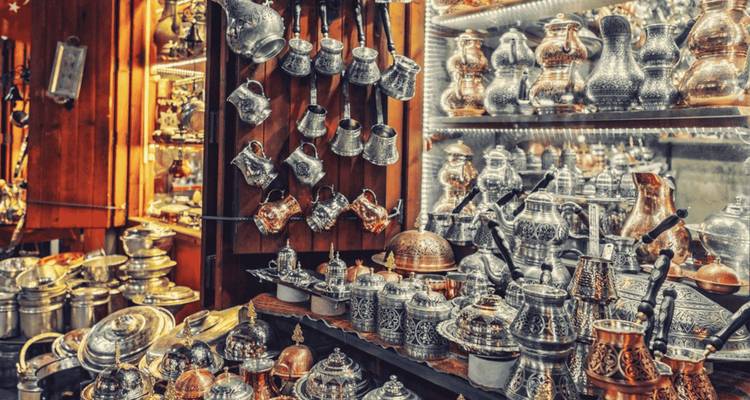 Display of intricately designed metalware and teapots.