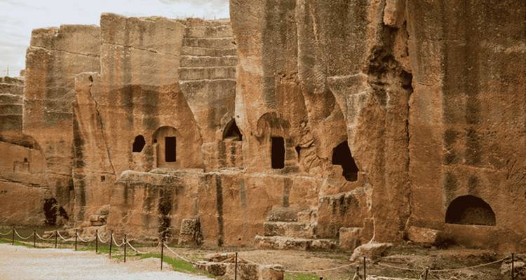 Ancient rock-cut architecture with cave openings.