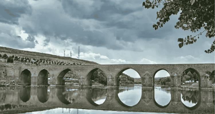 Historic stone bridge with reflections in the river.