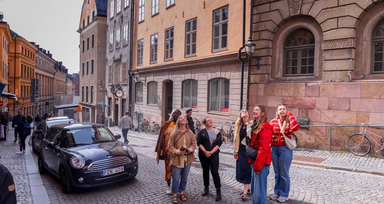 Turistas explorando calles empedradas en una ciudad histórica.