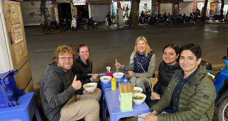 Group of people enjoying street food at night.