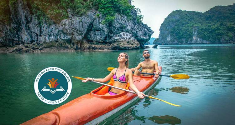Couple kayaking in a scenic area with rocky formations.