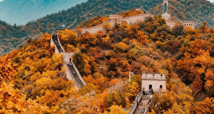 Great Wall of China stretching over a colorful autumnal landscape.