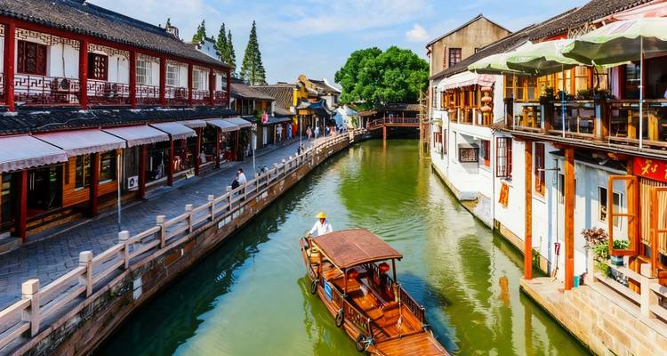 Canal with boats and traditional architecture on either side.