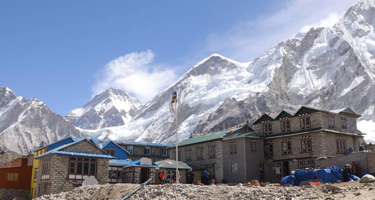 Village with colorful houses in snowy mountains.