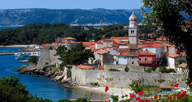 A charming coastal town with rustic stone buildings by the sea.
