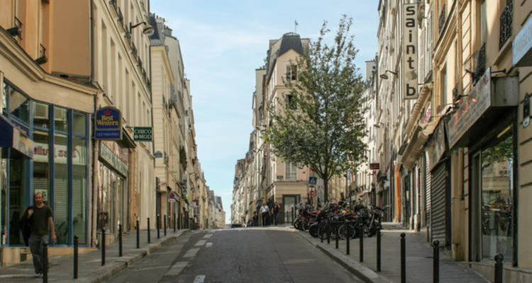 A quiet residential street lined with classic buildings.