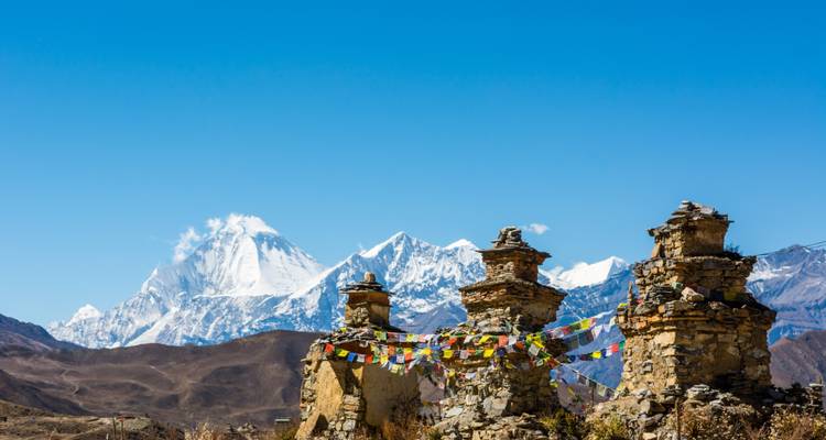 Prayer flags in front of snow-capped mountains.