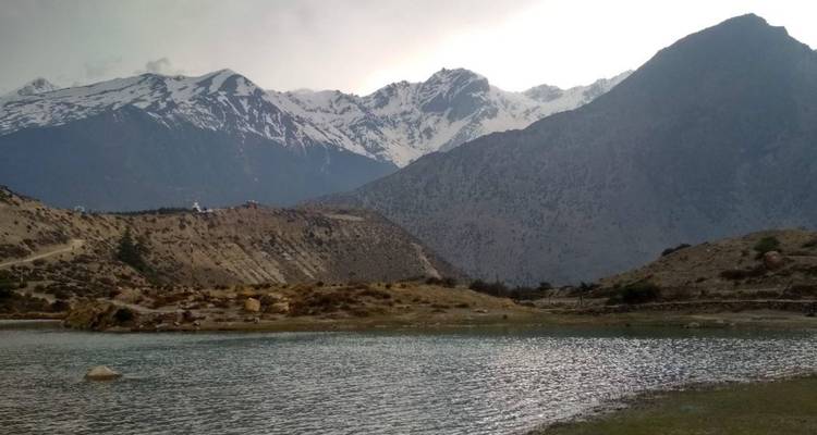 Peaceful lake surrounded by mountains.