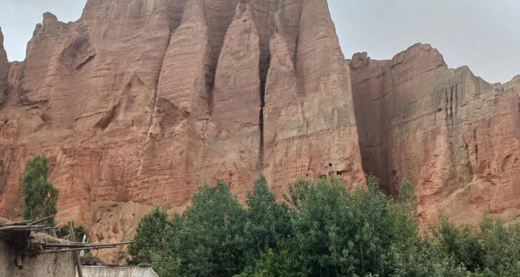 Red rock cliffs and green vegetation.