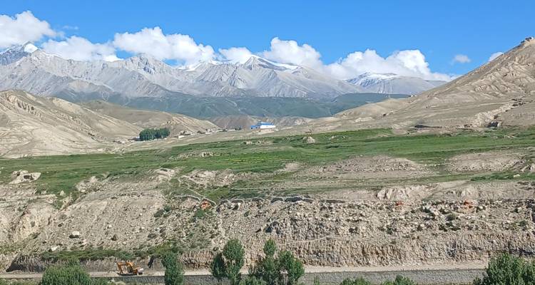 Mountainous landscape with a distant building.