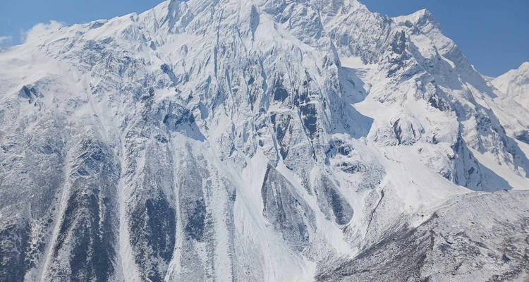 Stunning snow-covered peaks under a clear sky.