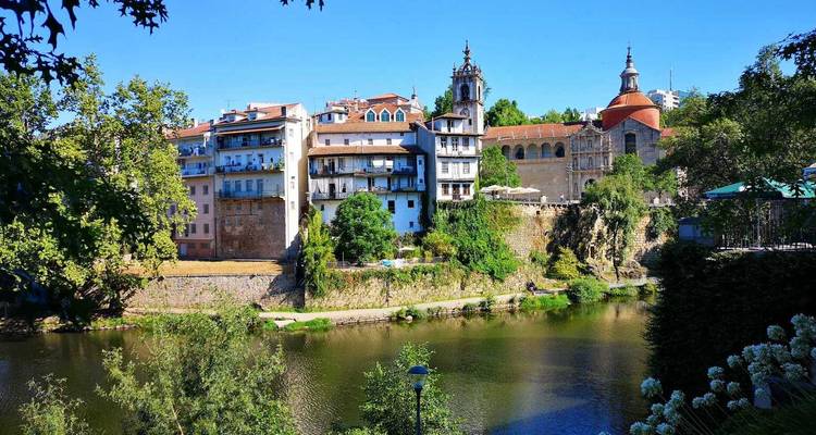 Riverside view of a city with historic buildings.