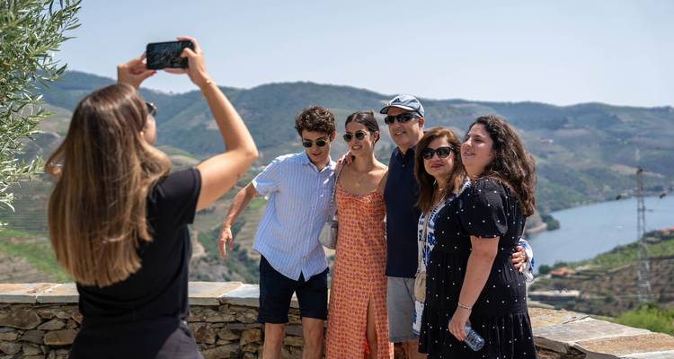Group of people taking a photo with a scenic background.