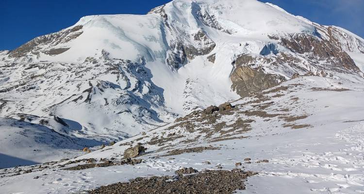 Snow-covered mountain landscape with sunlight on peaks.