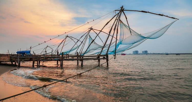 Fishing nets over water at sunset.