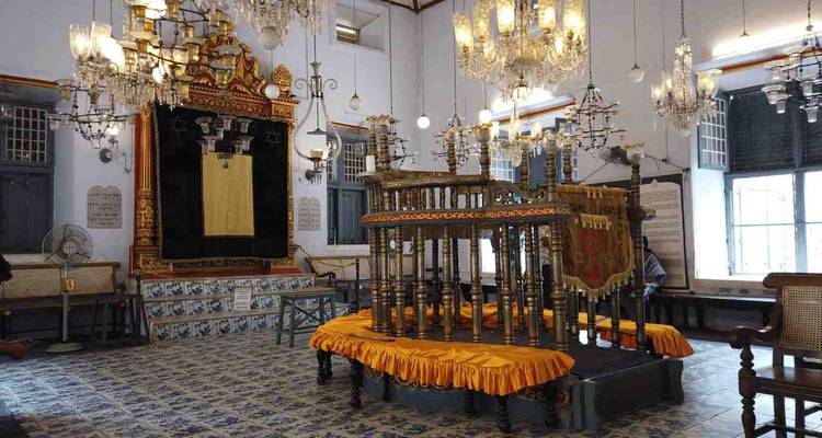 Interior of an ornate synagogue with chandeliers.
