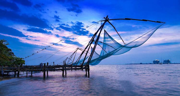 Dramatic view of fishing nets by the sea at dusk.
