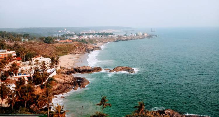 Coastal shoreline with rocky outcrops and waves.
