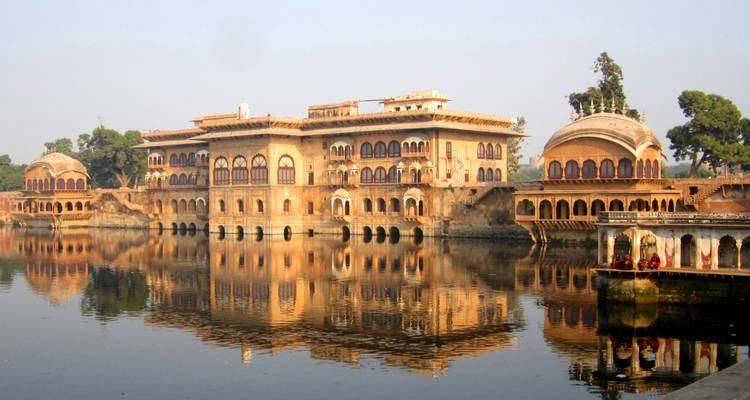 A historical building reflected in the water.