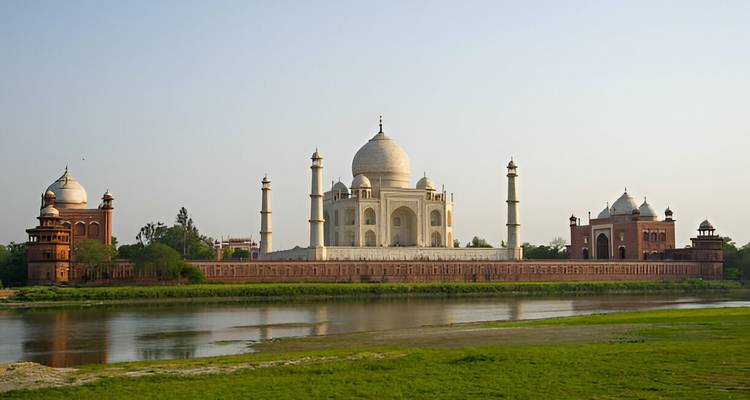 Distant view of the Taj Mahal by the river.