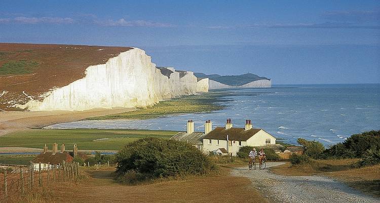 White chalk cliffs and cottages by the sea.