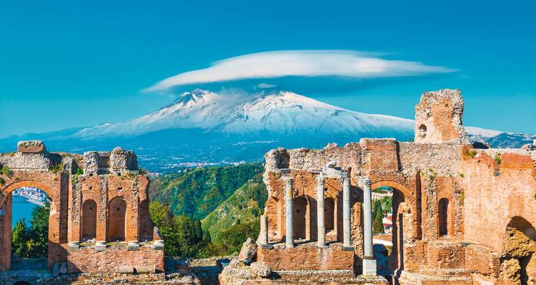 Ancient ruins with a mountain in the background.