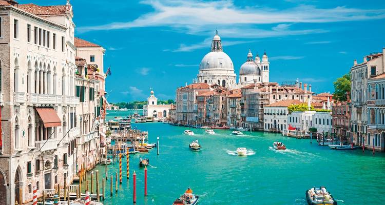 Venetian cityscape with iconic canal and domed church.