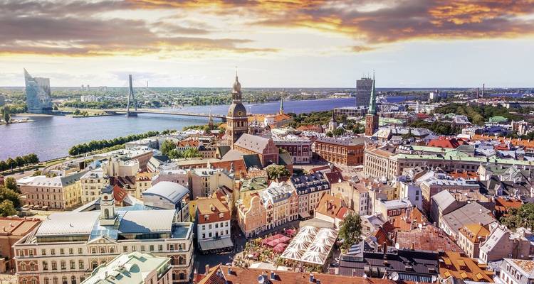 Riga cityscape during sunset with a river view.